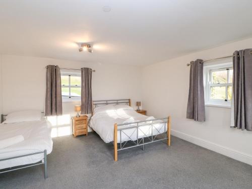 Ένα ή περισσότερα κρεβάτια σε δωμάτιο στο Auckland Cottage