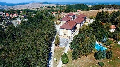 an aerial view of a house with a swimming pool at Apartment White Bear in Zlatibor