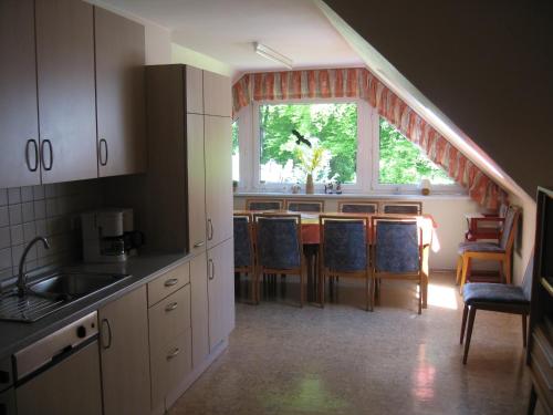 a kitchen with a table and chairs and a window at In der Waldemei in Medebach