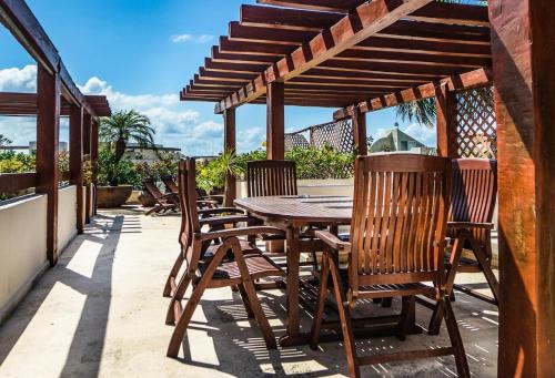 a wooden table and chairs on a patio at Royal Palms 10 condo in Playa del Carmen