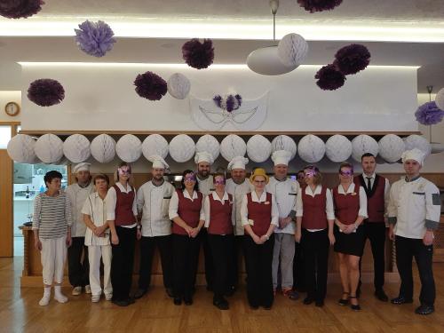 a group of people posing for a picture in a restaurant at Spa Hotel Diana in Františkovy Lázně