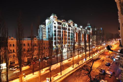 a large building is lit up at night at Cheap Apartments in Kyiv