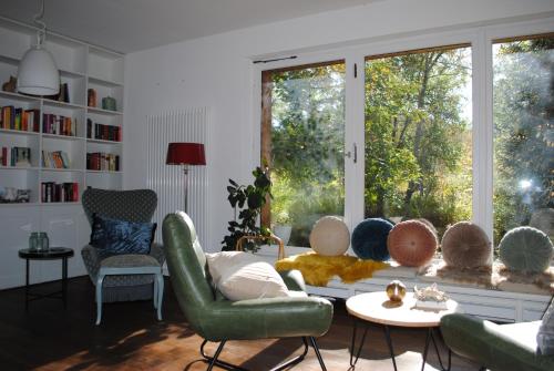 a living room with a couch and chairs and a window at Hotel am Bach in Hinterzarten