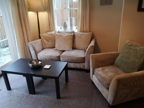 a living room with a couch and a coffee table at Coastal Escape Deal - 2 Bedroom House at Kent Escapes Short Lets & Serviced Accommodation Kent, Wifi in Deal