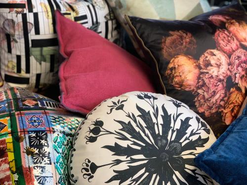 a pile of pillows sitting on top of a couch at COSMOPOLITAN APARTMENTS Zürich Seefeld in Zürich
