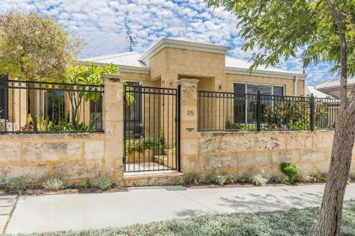 a house with a wrought iron fence at Ocean Keys Cottage - Free WiFi in Mindarie