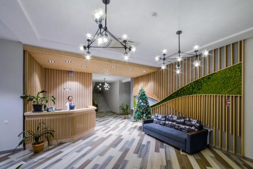 a lobby with a blue couch and a christmas tree at Гостиничный комплекс Be Fine in Besqaynar
