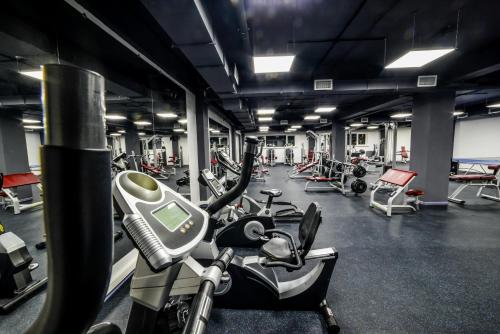 a gym with several treadmills and exercise bikes at Гостиничный комплекс Be Fine in Besqaynar