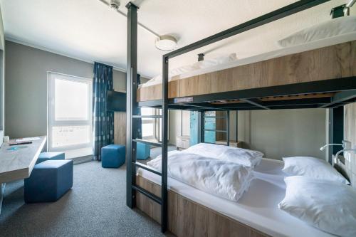 a bed room with two bunk beds in it at WIROtel Mittelmole in Warnemünde