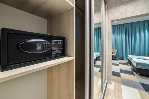 a room with a television on a wall at Гостиничный комплекс Be Fine in Besqaynar