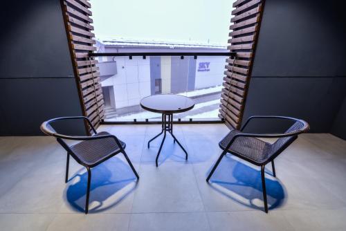two chairs and a table in a room with a window at Гостиничный комплекс Be Fine in Besqaynar