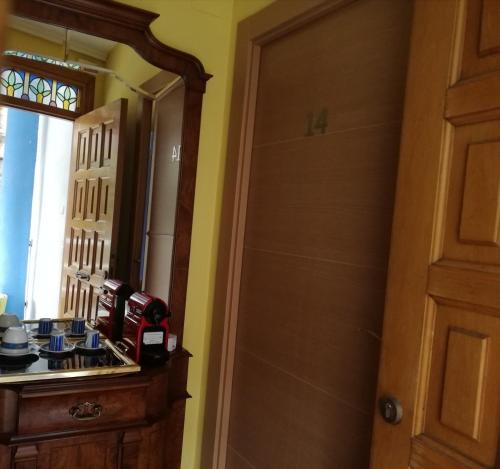 a kitchen with a sink and a mirror at Txoko Maitea Pentsioa in Urnieta