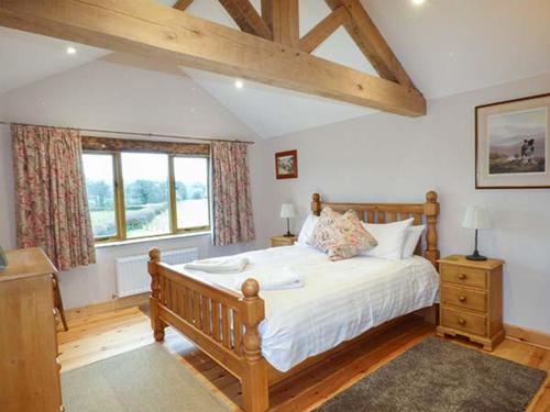 a bedroom with a large bed and a window at Lane Foot Cottage in Lancaster