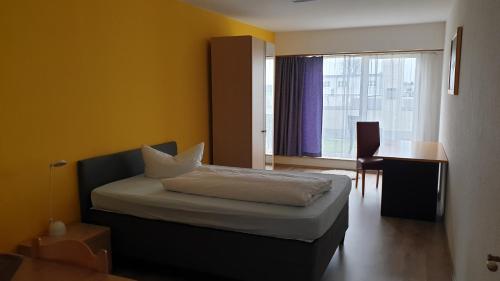 Ένα ή περισσότερα κρεβάτια σε δωμάτιο στο Hotel Arheilger Hof