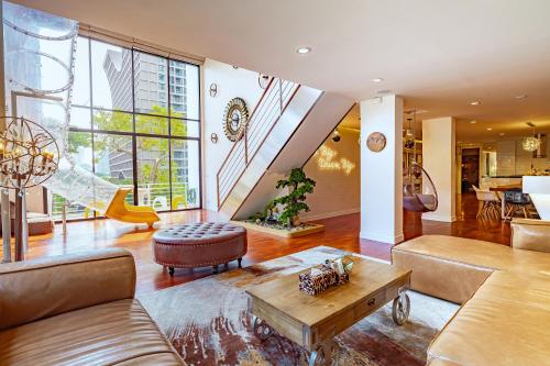 a living room with a couch and a table at Benviar Tonson Residence in Bangkok