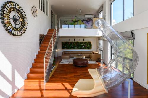 a staircase in a house with a glass slide at Benviar Tonson Residence in Bangkok