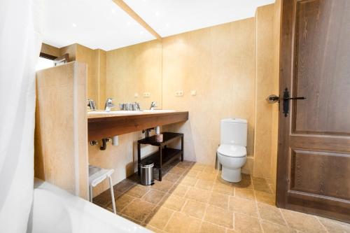 un baño con inodoro y lavabo en Apartaments Esquirol El Tarter, en El Tarter
