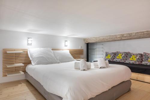 a bedroom with a large white bed with two pillows at DIFY D'Aguesseau - Quai du Rhône in Lyon