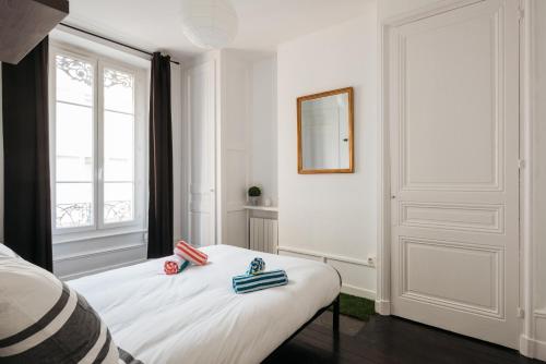 a white room with a bed and a window at DIFY Glamour - Place des Brotteaux in Lyon