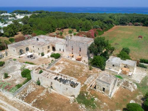 an aerial view of an old building with the ocean in the background at Masseria Specchiulla in Otranto