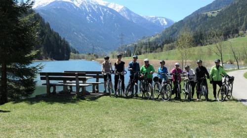 a group of people standing next to a picnic table at Haus Pleterski in Obervellach