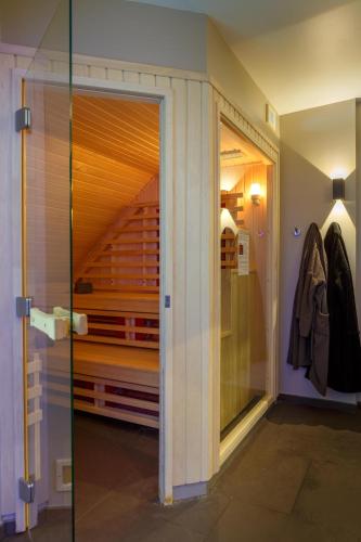 a walk in closet with a glass door in a room at Best Western Les Bains Hotel et SPA in Perros-Guirec