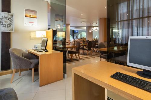 an office with a desk with a computer on it at Holiday Inn Express Cape Town City Centre by IHG in Cape Town