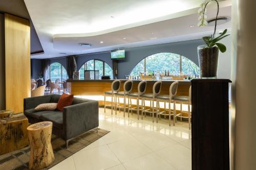 a bar with a row of chairs in a room at Holiday Inn Express Cape Town City Centre by IHG in Cape Town
