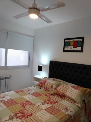a bedroom with a bed with a quilt on it at La Recova in Alta Gracia