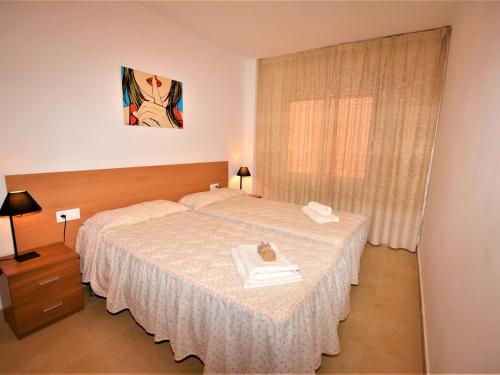 a hotel room with a bed and a picture on the wall at Villa Service - Suïssa 2 in Calafell