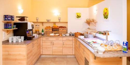 a large kitchen with wooden cabinets and a counter at Pension Einsiedl in Ottenschlag