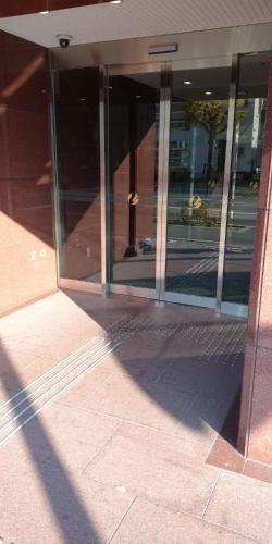 a building with glass windows on the side of it at Kyoto Universal Hotel Karasuma in Kyoto