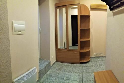 a hallway with a wooden cabinet in a room at Apartaments near Švyturio arena in Klaipėda