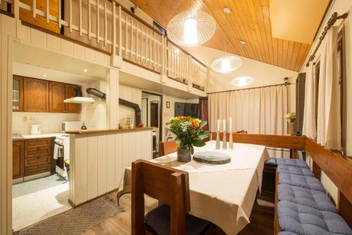 a kitchen and dining room with a table and chairs at Chata Borik in Svit