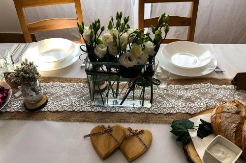 a table with a vase of flowers and two hearts at Dom św. Józefa in Szczecin