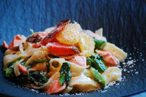a pasta dish with vegetables on a blue plate at Hotel Trusty Tokyo Bayside in Tokyo