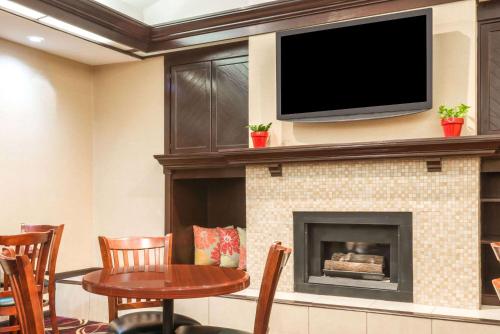 a living room with a fireplace with a flat screen tv at Hawthorn Extended Stay by Wyndham Dayton in Dayton