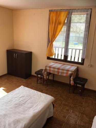 a bedroom with a bed and a window at Forest Villa- domki in Susiec