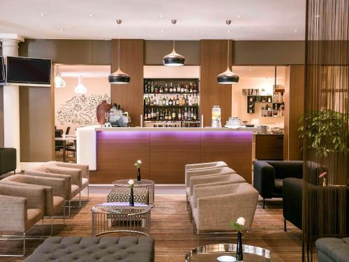 a lobby of a hotel with a bar at Sydney Central Hotel managed by The Ascott Limited in Sydney