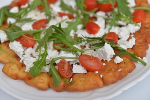 a white plate of food with tomatoes and cheese at Dom św. Józefa in Szczecin