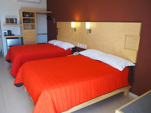 Łóżko lub łóżka w pokoju w obiekcie Nova Hotel