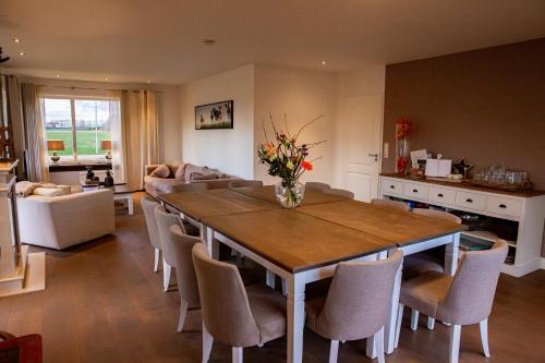 a kitchen and living room with a table and chairs at Boerderij Zonneveld in Rossum