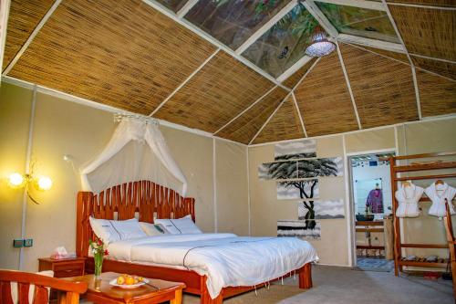 a bedroom with a bed in a room with a ceiling at Mara Chui Eco-Resort in Sekenani