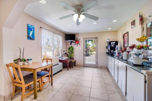 a kitchen with a table and a ceiling fan at Econo Lodge in Walterboro
