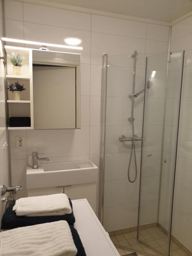 a bathroom with a shower and a sink at Strand Apartments in Kvaloysletta