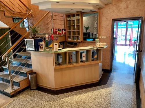 a lobby with a counter and a staircase at Hotel Brkic in Sarajevo