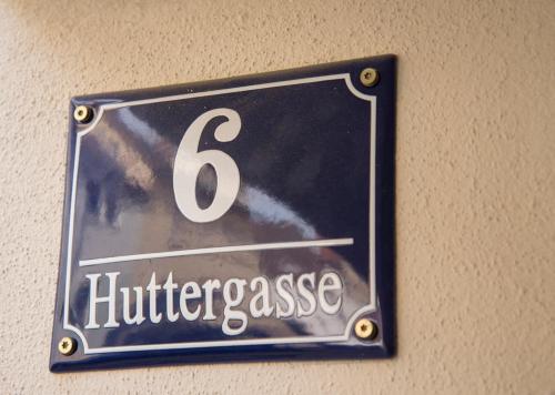 a sign hanging on a wall with the number six at RefuKium Altstadtscheune in Weißenburg in Bayern