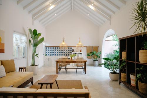 a living room with a table and potted plants at Happy Together By Kresna Hospitality in Seminyak