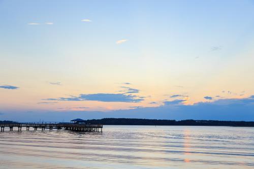 a pier on the water with a sunset at Breakers 215 in Hilton Head Island