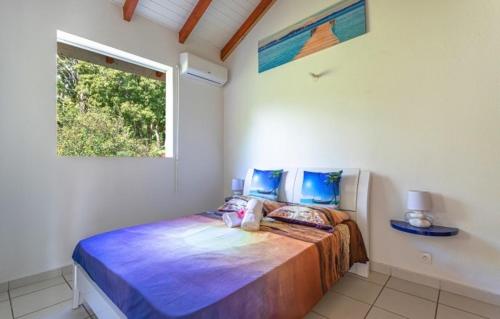 Ein Bett oder Betten in einem Zimmer der Unterkunft Ô Coeur Des Tropiques